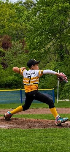 A young pitcher working on their delivery. A young pitcher working on their delivery.