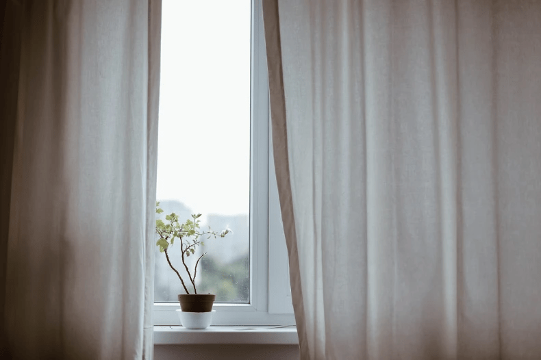 Curtains closed across windows. Curtains closed across windows.