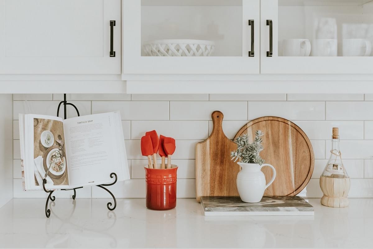 Cook book, cutting boards and jugs on a kitchen work top Cook book, cutting boards and jugs on a kitchen work top