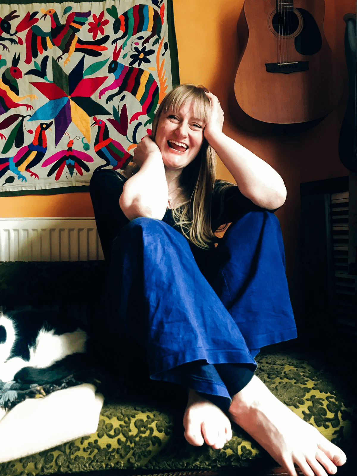 Emilie Joy Rowell, embodiment coach sits with her cat. Emilie Joy Rowell, embodiment coach sits with her cat.