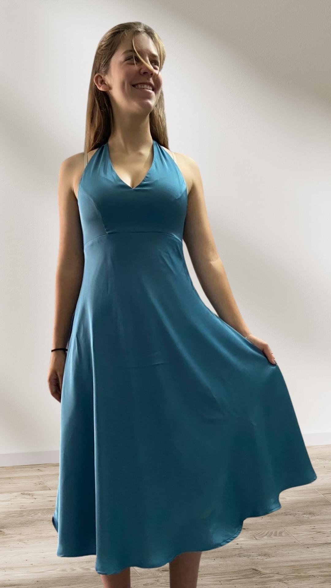 The ease of summer vacations in silk shine through for this young woman who wears a halter neck dress that's as light as a summer's day. The ease of summer vacations in silk shine through for this young woman who wears a halter neck dress that's as light as a summer's day.