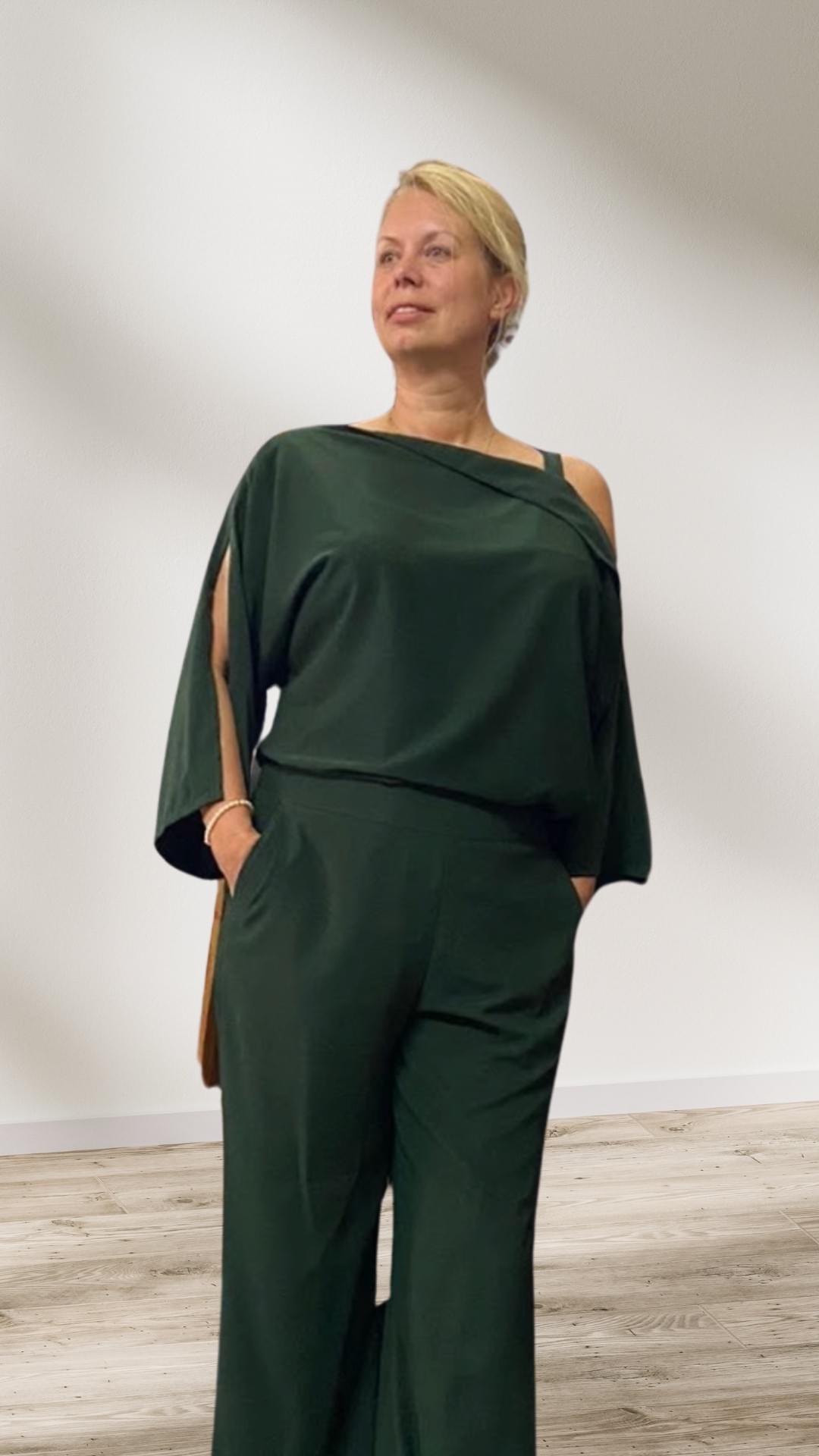 Sophisticated and versatile in forest green silk palazzo pants and off-shoulder top — expressing personal style suited to both holiday and business casual. Sophisticated and versatile in forest green silk palazzo pants and off-shoulder top — expressing personal style suited to both holiday and business casual.