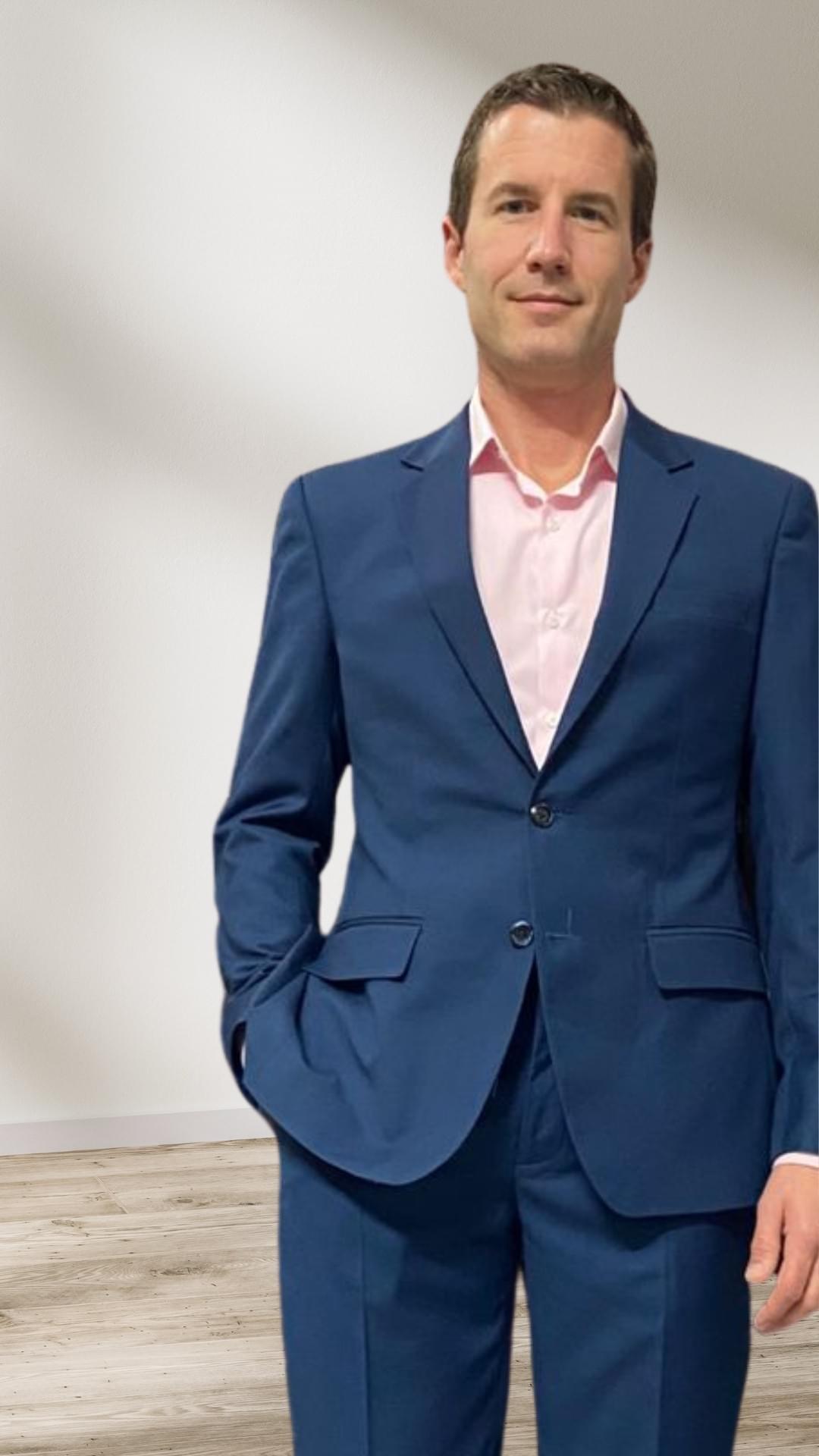 Relaxed businessman in a tailored blue suit — fit and fabric signalling readiness and quiet confidence. Relaxed businessman in a tailored blue suit — fit and fabric signalling readiness and quiet confidence.