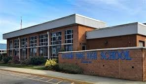 Brick building and monument wall with Union Pines High School signage