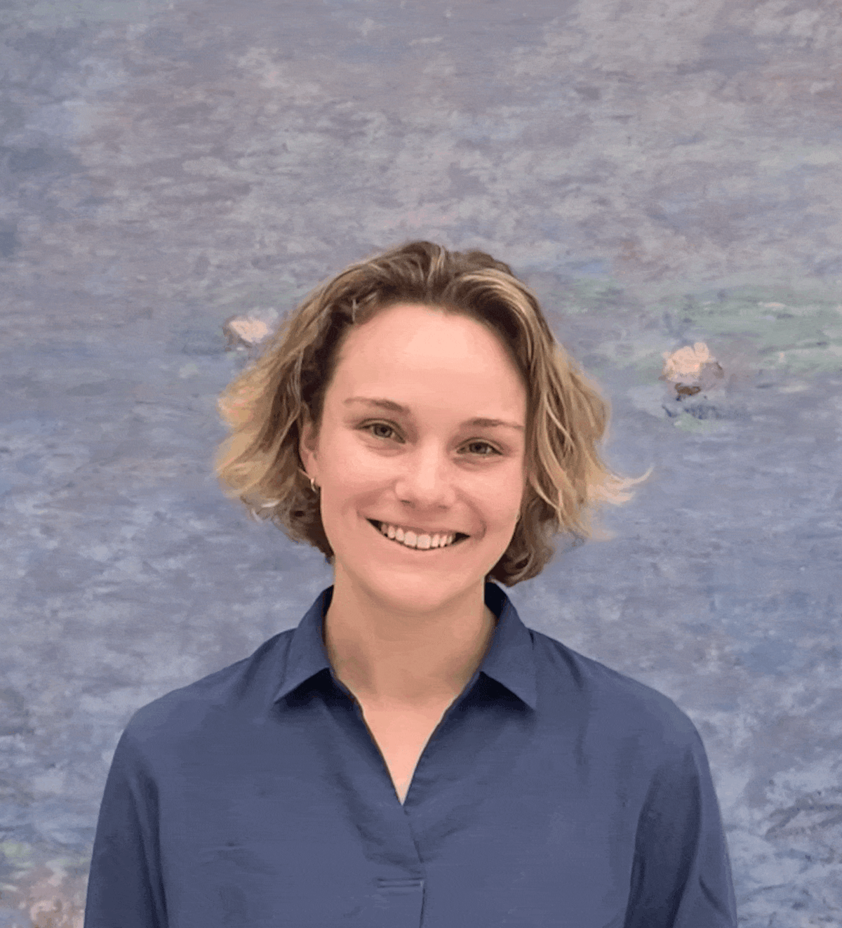 Smiling woman with bobbed hair pictured in front of what looks like a Monet painting details Smiling woman with bobbed hair pictured in front of what looks like a Monet painting details