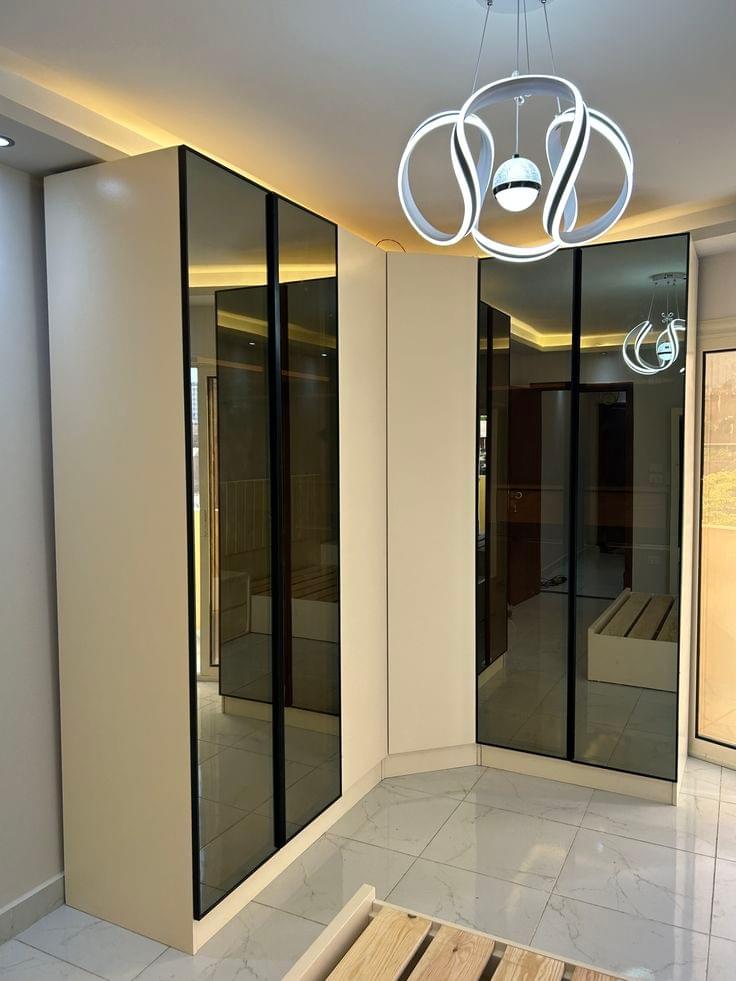 We specialize in detailing all types of cabinets and closets, including corner cabinets, wall cabinets, and dressing room closets, using high-quality materials to ensure durability and beauty. Types of safes Features list Kingdom of cabinet delivery with 15 years of experience in cabinet and wardrobe tailoring. We manufacture all types of wardrobes and cabinets such as corner wardrobes, wall wardrobes, dressing rooms, with hydraulic doors, arrow doors, wooden doors wardrobes, glass doors wardrobes. I want the site to include a detailed explanation of the types of wardrobes and cabinets, dressing rooms, tailoring of cabinets, wardrobes, and dressing rooms in Qatif, Dammam, Khobar, and Dhahran. We specialize in detailing all types of cabinets and closets, including corner cabinets, wall cabinets, and dressing room closets, using high-quality materials to ensure durability and beauty. Types of safes Features list Kingdom of cabinet delivery with 15 years of experience in cabinet and wardrobe tailoring. We manufacture all types of wardrobes and cabinets such as corner wardrobes, wall wardrobes, dressing rooms, with hydraulic doors, arrow doors, wooden doors wardrobes, glass doors wardrobes. I want the site to include a detailed explanation of the types of wardrobes and cabinets, dressing rooms, tailoring of cabinets, wardrobes, and dressing rooms in Qatif, Dammam, Khobar, and Dhahran.