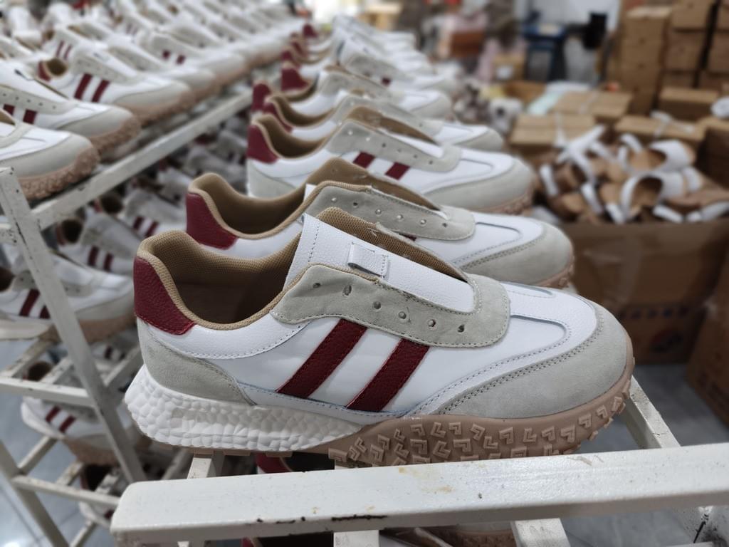 Leather sneaker production line – quality control and craftsmanship in footwear factory Leather sneaker production line – quality control and craftsmanship in footwear factory