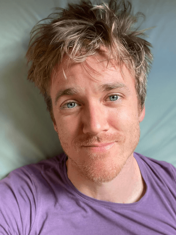 photo of steve dean wearing a purple tshirt, looking into the camera photo of steve dean wearing a purple tshirt, looking into the camera