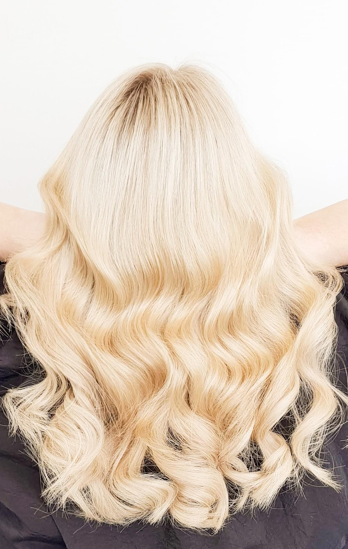 Golden blonde hair with voluminous curls at OMG Hair and Beauty. Golden blonde hair with voluminous curls at OMG Hair and Beauty.