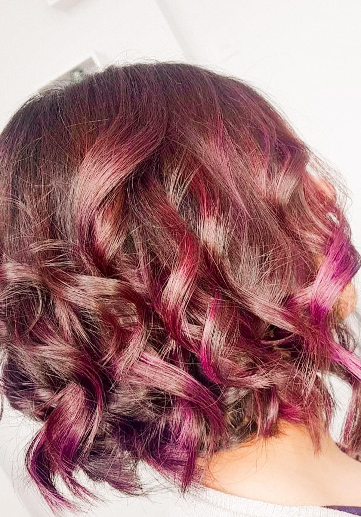 Rich burgundy hair color styled with soft curls at OMG Hair and Beauty. Rich burgundy hair color styled with soft curls at OMG Hair and Beauty.