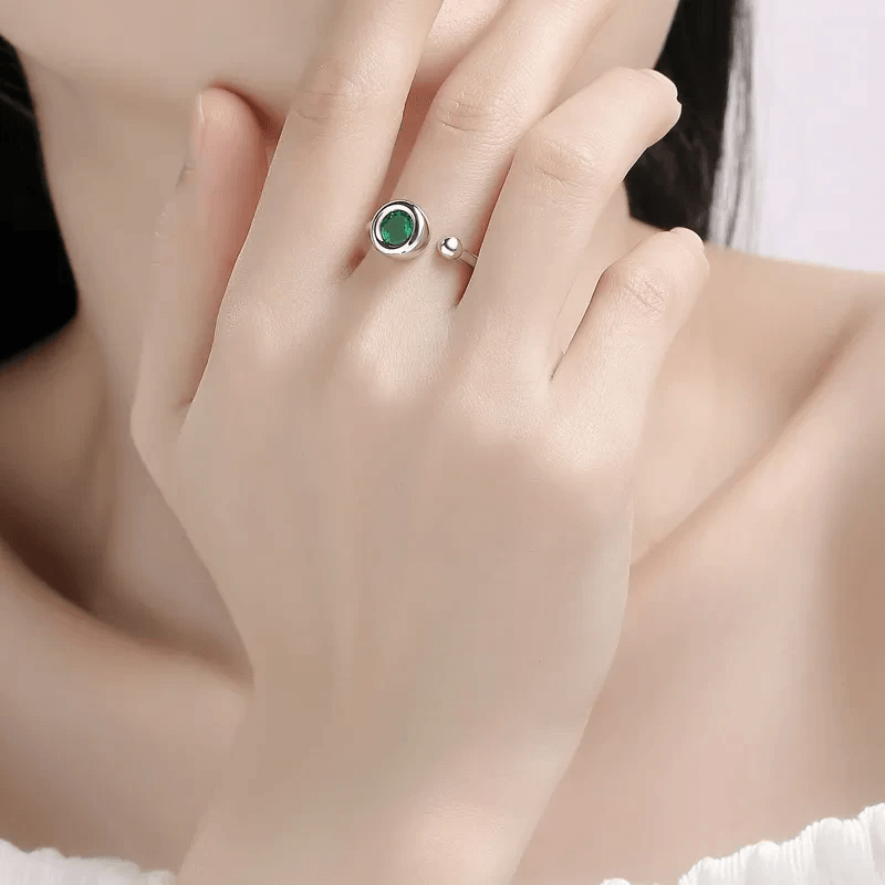 Elegant dark green moissanite ring on woman's hand Elegant dark green moissanite ring on woman's hand