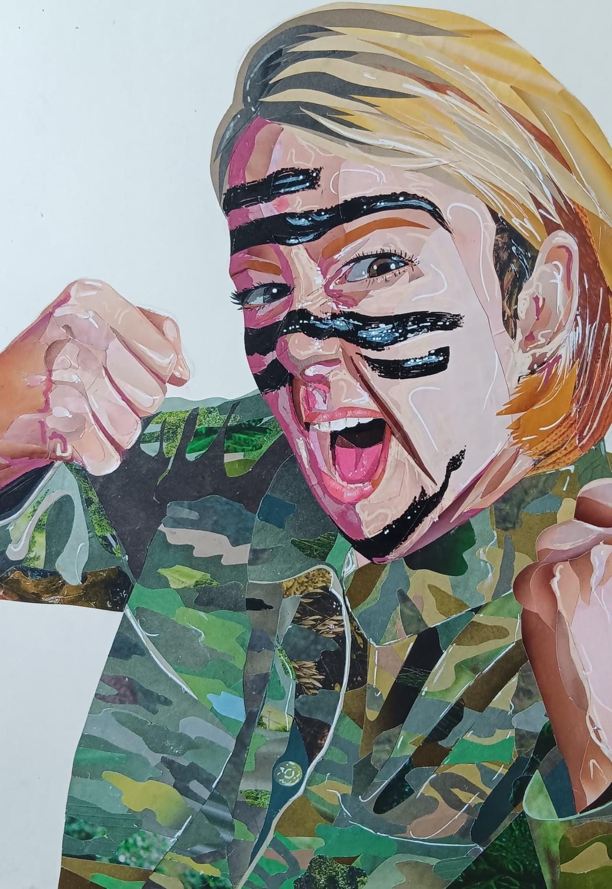 Collage artwork called Fighting The Seven Signs of Ageing. Self portrait. Woman with blonde, bobbed hair, wearing a khaki jacket, black camouflage face paint across her cheeks, fists bunched and raised ready to fight. Collage artwork called Fighting The Seven Signs of Ageing. Self portrait. Woman with blonde, bobbed hair, wearing a khaki jacket, black camouflage face paint across her cheeks, fists bunched and raised ready to fight.