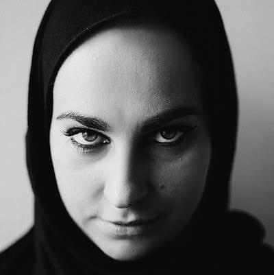 a picture of woman wearing a hijab looking at the camera a picture of woman wearing a hijab looking at the camera