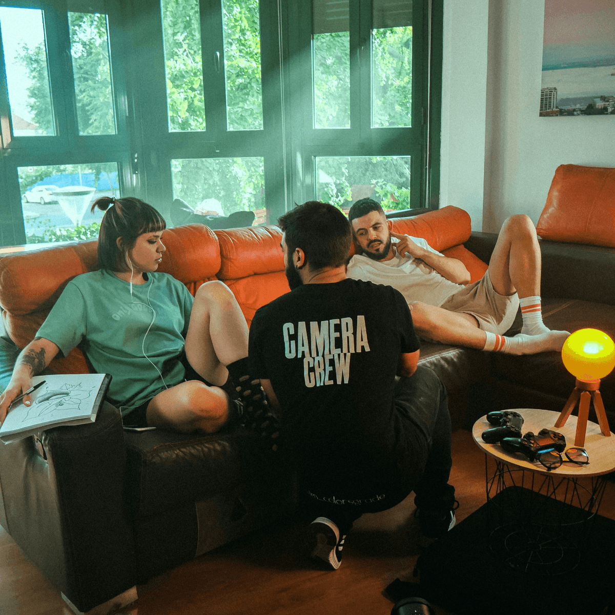 three people sitting around relaxed and talking three people sitting around relaxed and talking