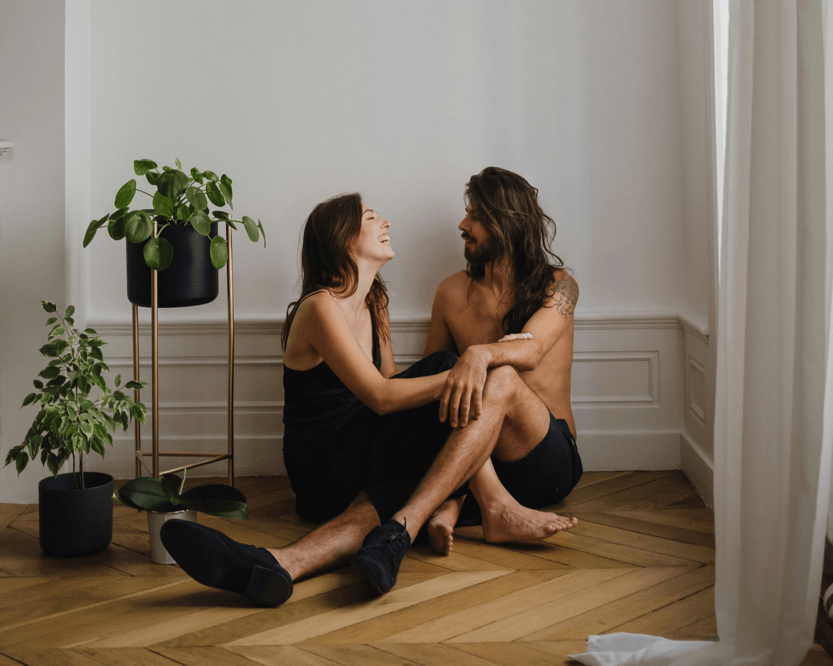 Couple holding each other on the floor Couple holding each other on the floor