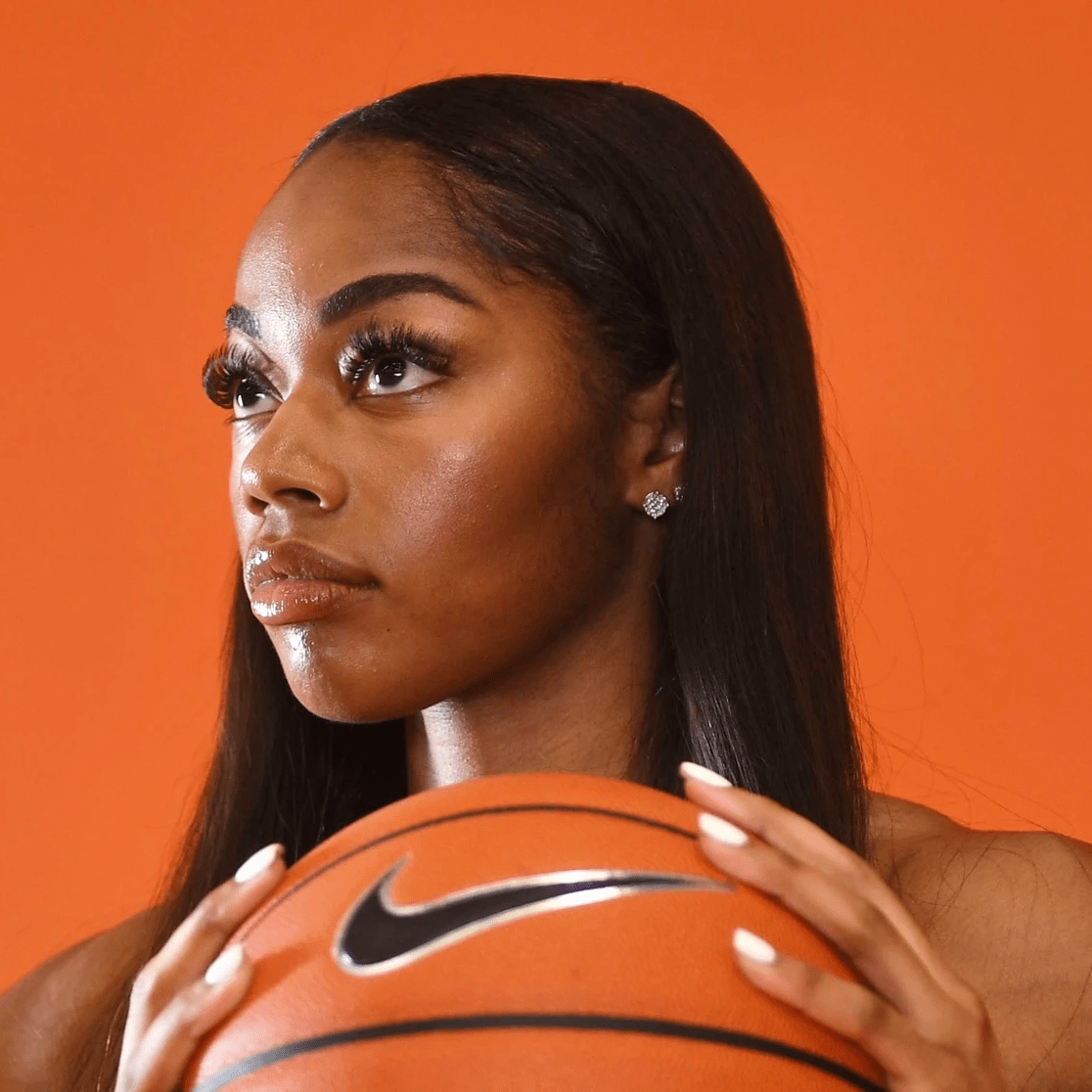 Charli looks out of frame while holding basketball Charli looks out of frame while holding basketball