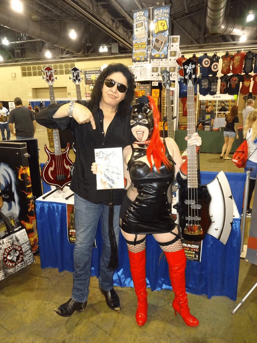 Rock legend Gene Simmons of the band KISS posed for pictures with Shawn's friend Princess Samantha in cosplay as the title character from Simmons's comic book creation "Dominatrix" just moments before Simmons used the remote control for an electric dog collar to give Shawn the shock of his life. Rock legend Gene Simmons of the band KISS posed for pictures with Shawn's friend Princess Samantha in cosplay as the title character from Simmons's comic book creation "Dominatrix" just moments before Simmons used the remote control for an electric dog collar to give Shawn the shock of his life.