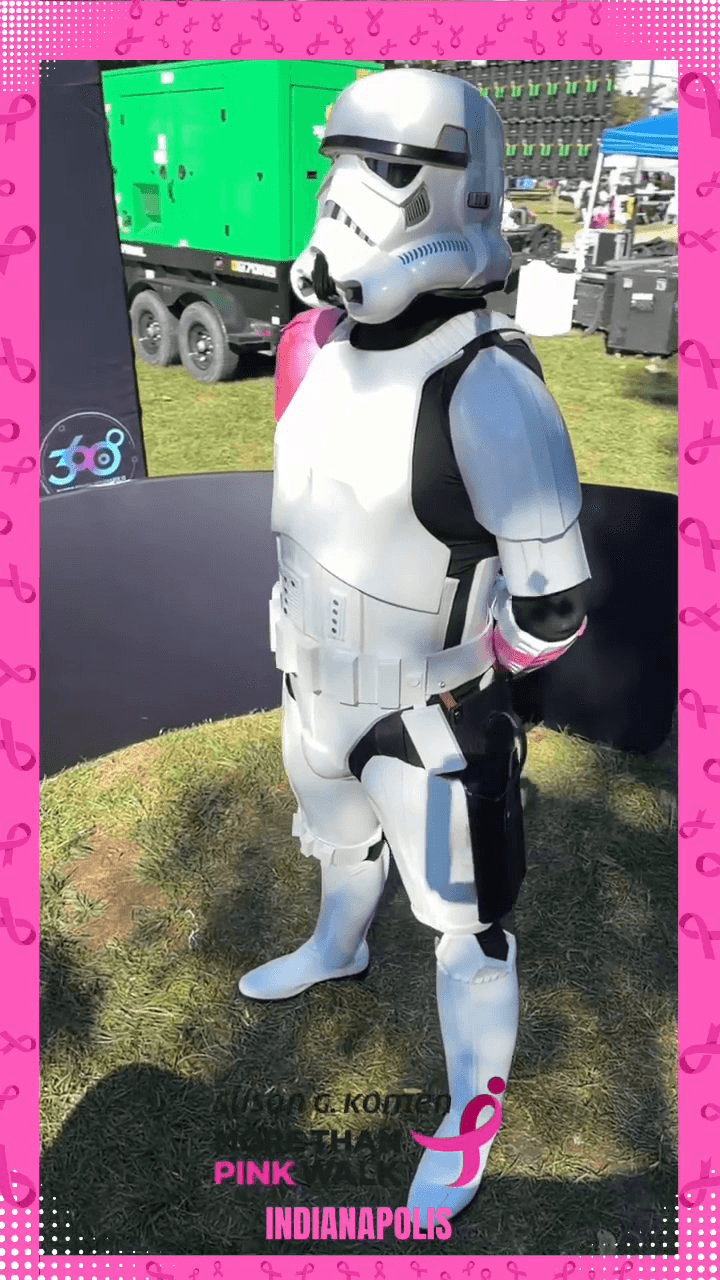 A person in a Stormtrooper costume with a pink sash stands on the 360 photo booth platform A person in a Stormtrooper costume with a pink sash stands on the 360 photo booth platform