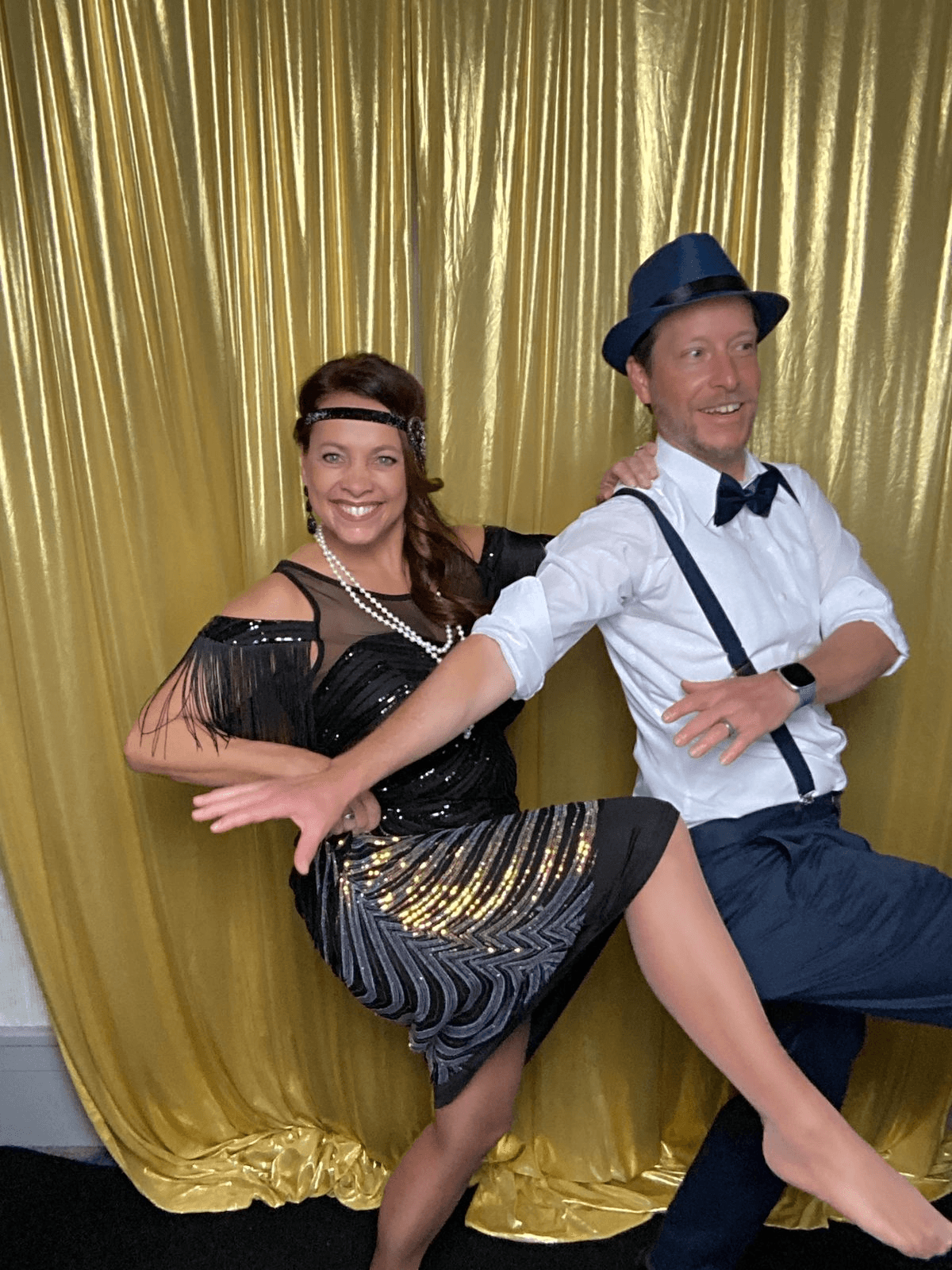 Couple in flapper dress and suspenders striking a dance pose at the Tap & Pose booth Couple in flapper dress and suspenders striking a dance pose at the Tap & Pose booth