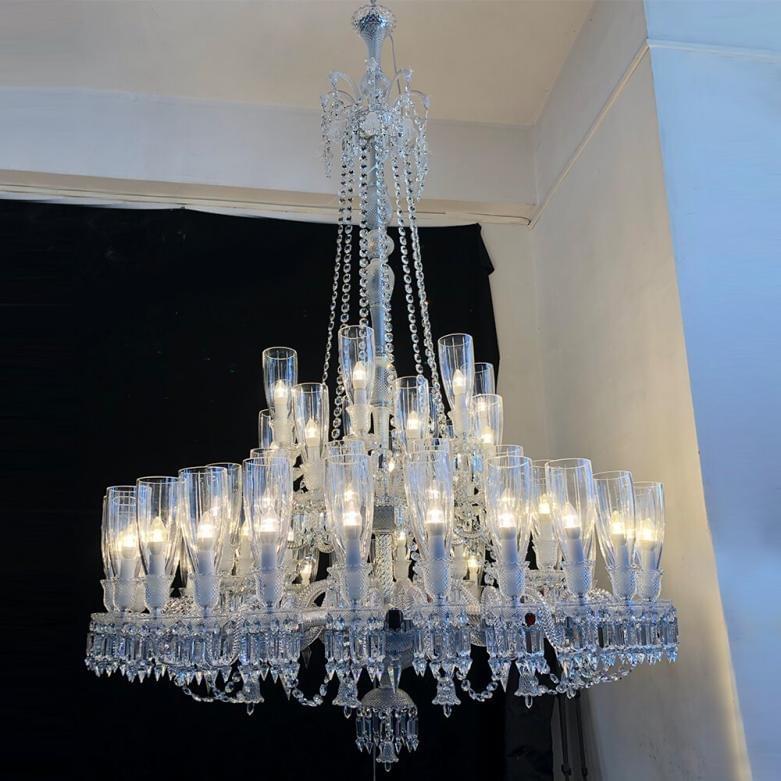 Dramatic gold Baccarat chandelier with numerous lights, designed for large event spaces and grand stairwells. Dramatic gold Baccarat chandelier with numerous lights, designed for large event spaces and grand stairwells.