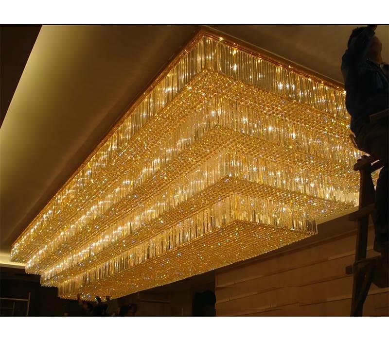 Grand multi-tier crystal chandelier lighting in event space Grand multi-tier crystal chandelier lighting in event space