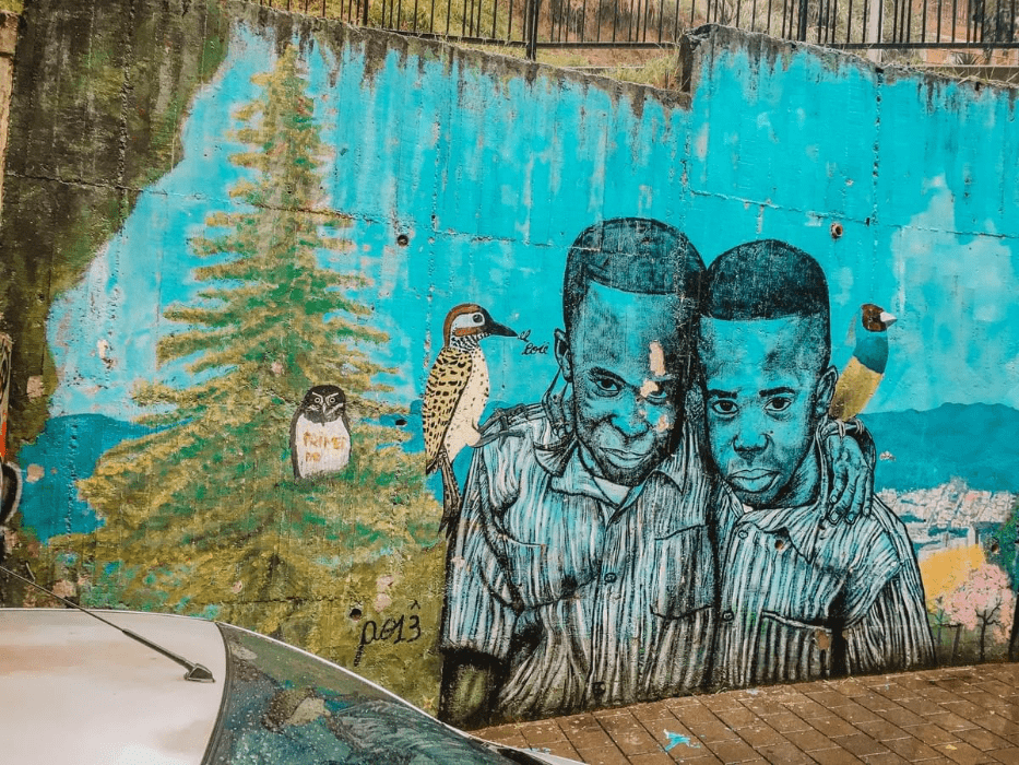 street art of 2 black boys with birds in the birds on their shoulders in comuna 13 Commune 13 San Javier in medellin street art of 2 black boys with birds in the birds on their shoulders in comuna 13 Commune 13 San Javier in medellin