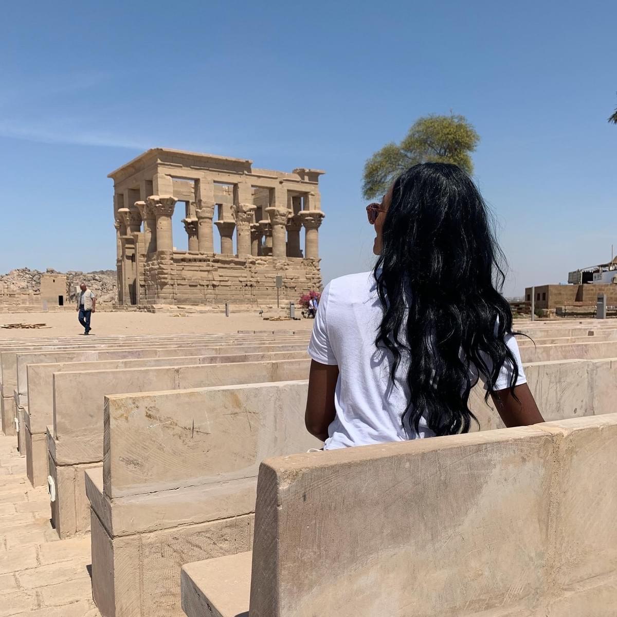 CulturesUncovered Brit Thompson Egypt sitting in theater Temple of Philae black girls travel CulturesUncovered Brit Thompson Egypt sitting in theater Temple of Philae black girls travel
