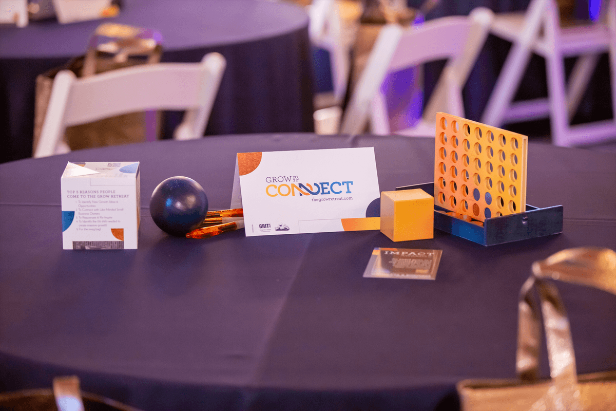 A table at the Grow Retreat displays the event theme Connect along with a connect 4 game and a ball. A table at the Grow Retreat displays the event theme Connect along with a connect 4 game and a ball.