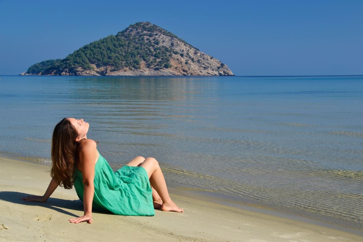 Yoga of You photo: Lady relaxing on beech in Greece. Yoga of You photo: Lady relaxing on beech in Greece.