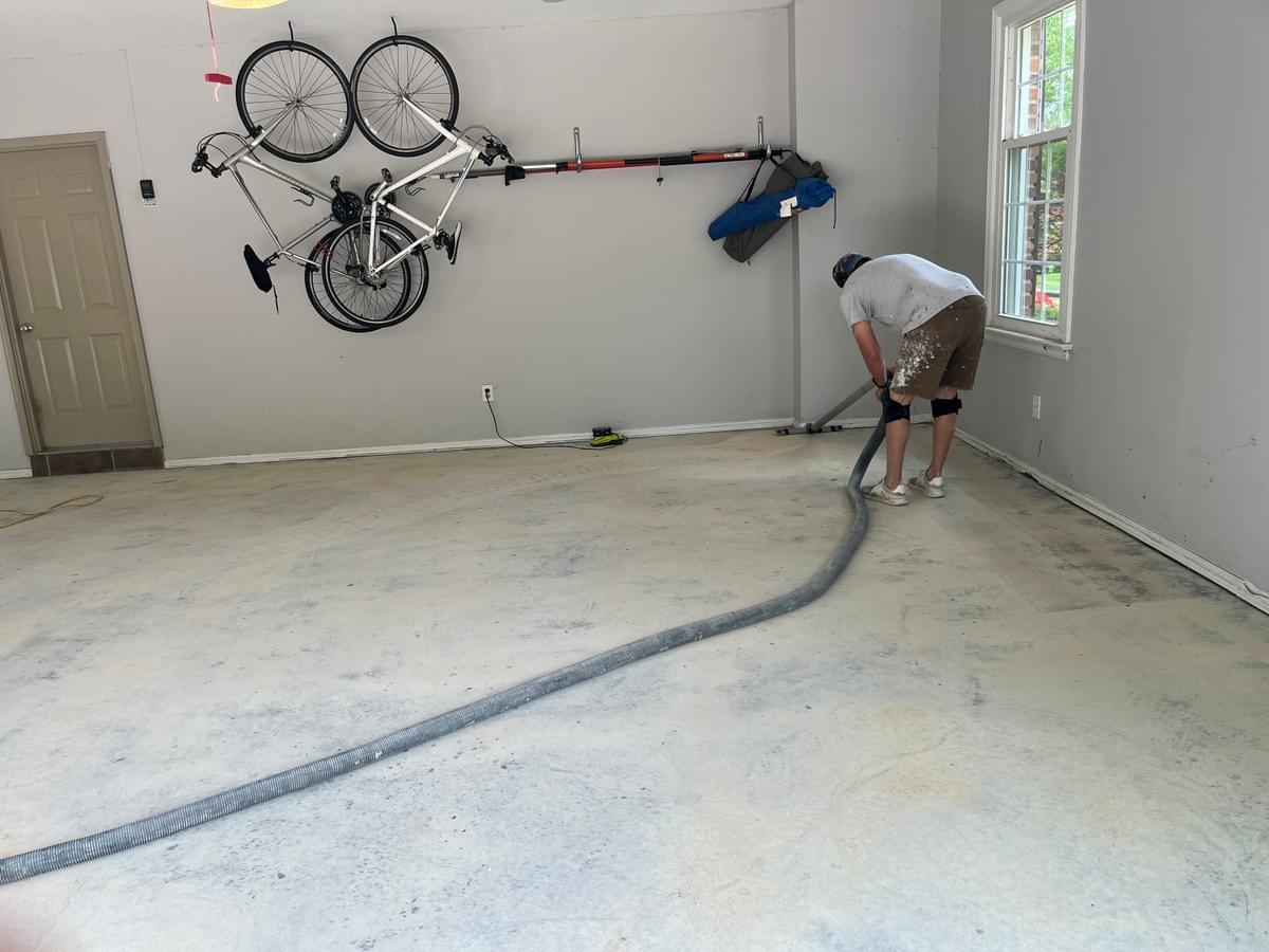 Quality Floor Coatings, a garage floor solutions company in Ellisville, MO, showcasing a garage floor makeover. The image shows a gray and black patterned epoxy floor installed by Quality Floor Coatings. The floor is glossy, smooth, and durable, providing a modern and functional look to the garage. Quality Floor Coatings, a garage floor solutions company in Ellisville, MO, showcasing a garage floor makeover. The image shows a gray and black patterned epoxy floor installed by Quality Floor Coatings. The floor is glossy, smooth, and durable, providing a modern and functional look to the garage.