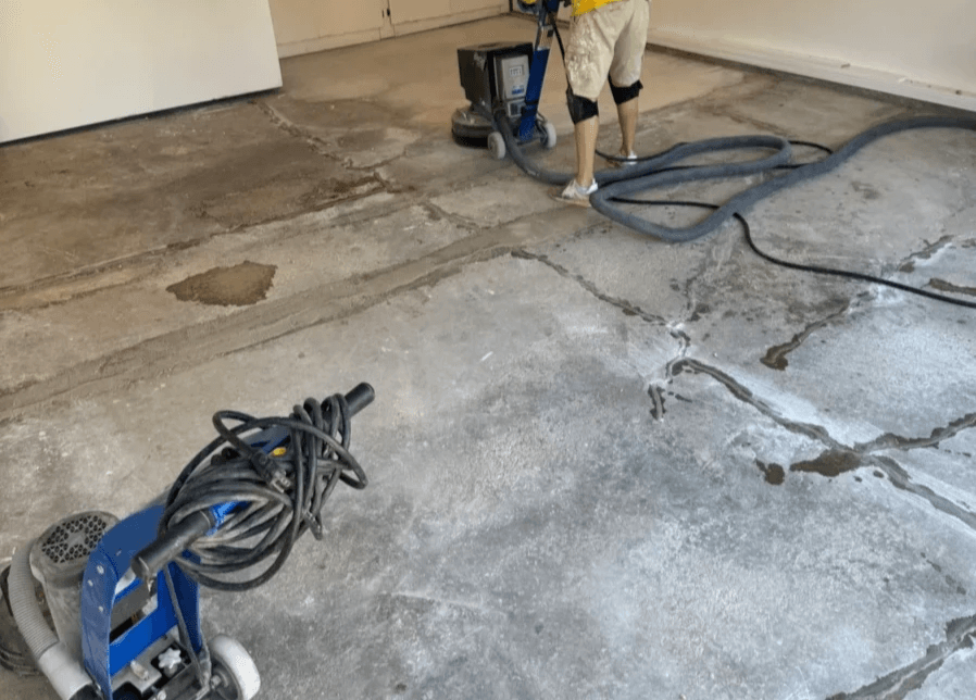 Quality Floor Coatings, a garage floor solutions company in Ellisville, MO, showcasing a garage floor makeover. The image shows a gray and black patterned epoxy floor installed by Quality Floor Coatings. The floor is glossy, smooth, and durable, providing a modern and functional look to the garage. Quality Floor Coatings, a garage floor solutions company in Ellisville, MO, showcasing a garage floor makeover. The image shows a gray and black patterned epoxy floor installed by Quality Floor Coatings. The floor is glossy, smooth, and durable, providing a modern and functional look to the garage.