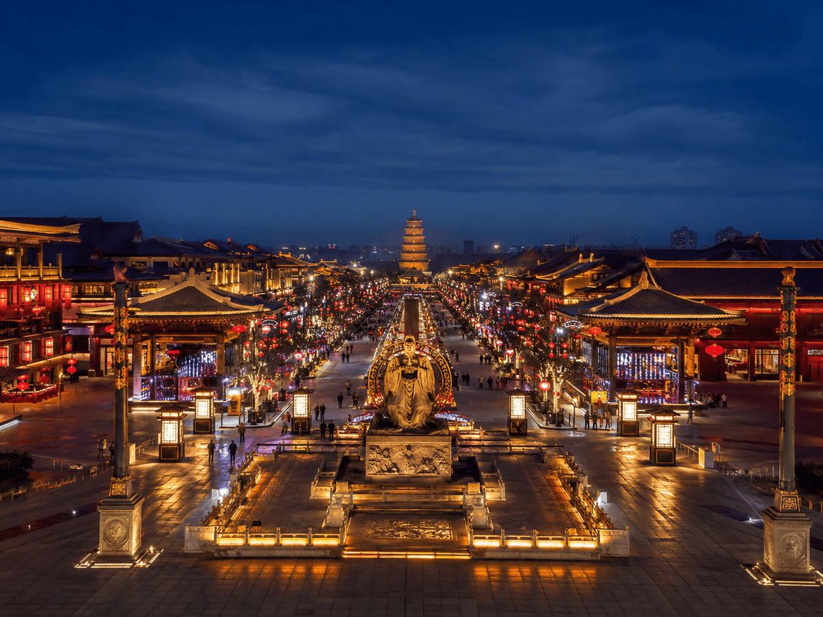 Grand Tang Mall in Xi’an illuminated at night with Tang-inspired buildings, lanterns and sculptures. Grand Tang Mall in Xi’an illuminated at night with Tang-inspired buildings, lanterns and sculptures.
