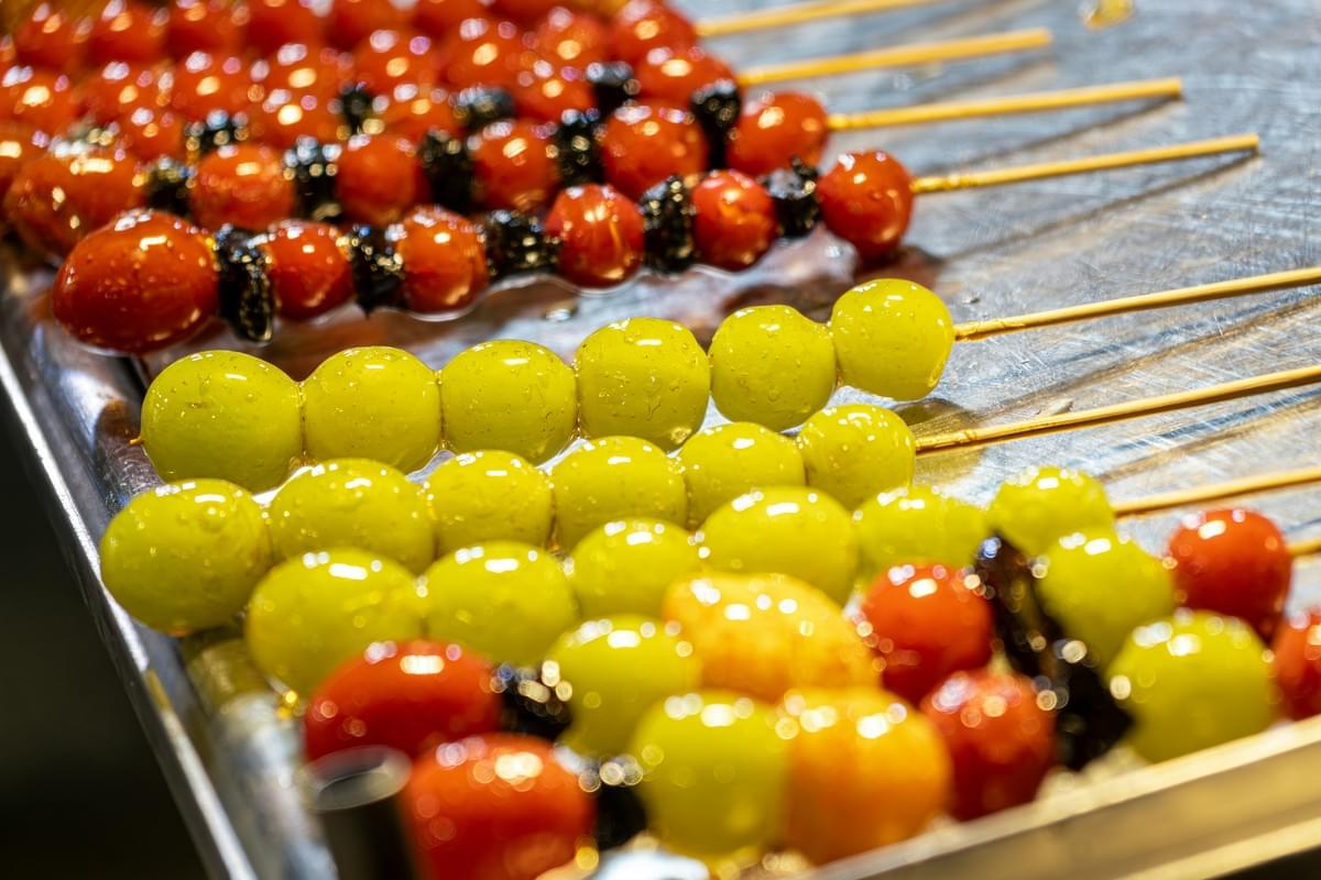 Colorful candied fruit skewers on a stick โ traditional Beijing street snack Tanghulu Colorful candied fruit skewers on a stick โ traditional Beijing street snack Tanghulu