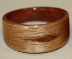 The interior liner is Australian Red Gum. This wood ring features a natural knot in the ASH and the ring is tapered to keep the featured knot oriented at the front of the ring.  Learn about the spiritual qualities of Australian Alpine Ash. The interior liner is Australian Red Gum. This wood ring features a natural knot in the ASH and the ring is tapered to keep the featured knot oriented at the front of the ring.  Learn about the spiritual qualities of Australian Alpine Ash.