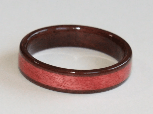 Black Walnut wood ring with wide inlay of Pink Ivory Wood Black Walnut wood ring with wide inlay of Pink Ivory Wood