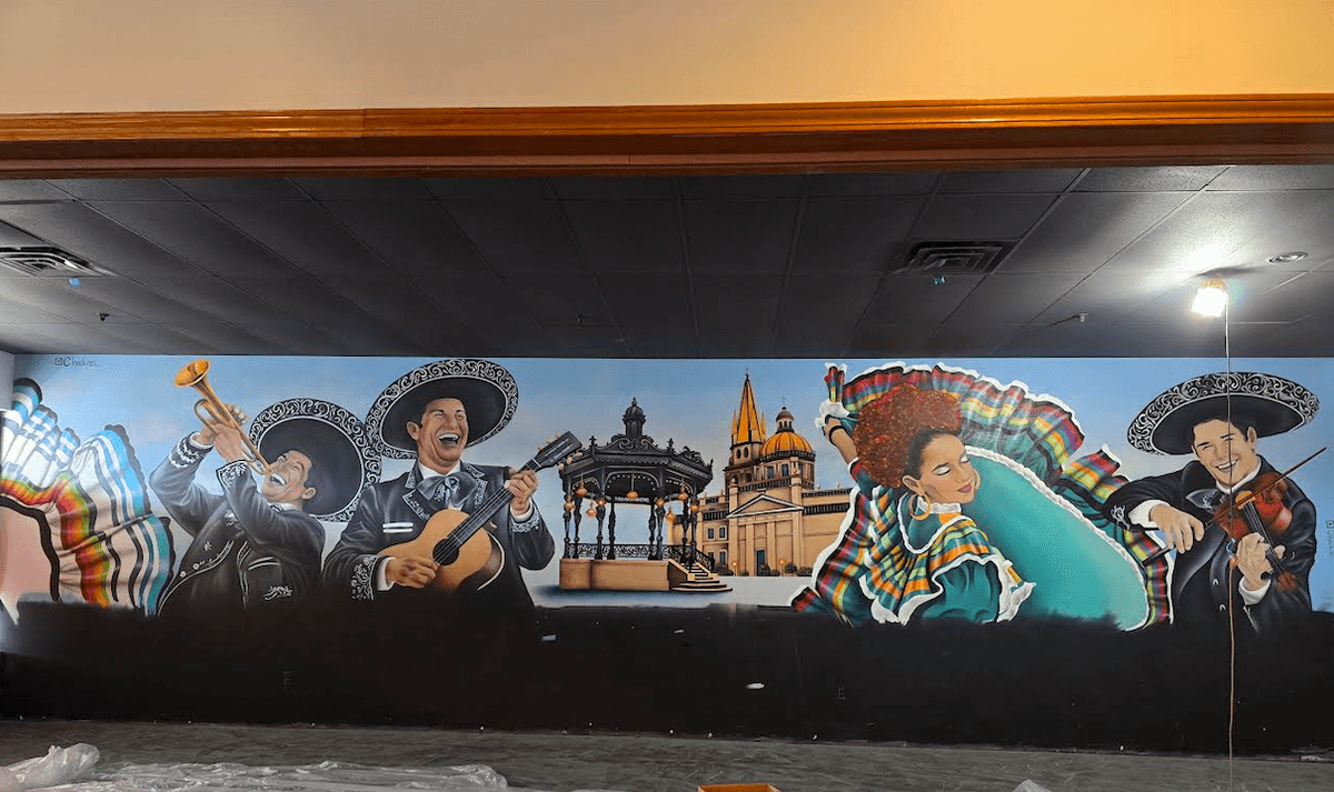 Large scale mural by California artist Sergio Martinez “Checkos” featuring mariachi musicians, folklórico dancers, and iconic Mexican architecture in a vibrant celebration of Mexican music, dance, and cultural heritage. Large scale mural by California artist Sergio Martinez “Checkos” featuring mariachi musicians, folklórico dancers, and iconic Mexican architecture in a vibrant celebration of Mexican music, dance, and cultural heritage.