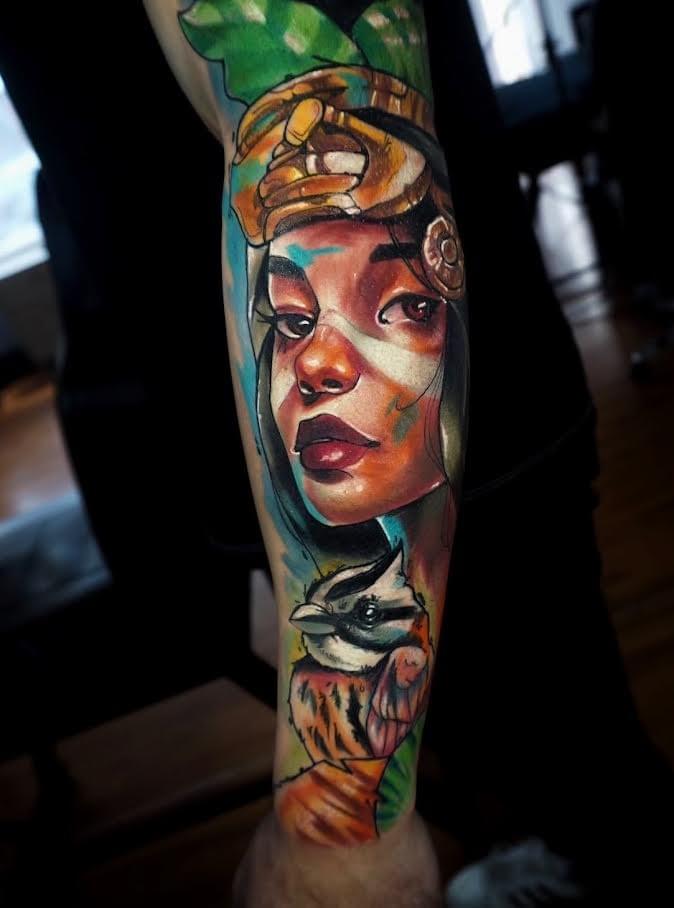 Illustrative color tattoo by Daniel Acosta León featuring a woman's portrait paired with an owl, blending expressive linework, rich color gradients, and nature inspired elements in a contemporary Colombian influenced style. Illustrative color tattoo by Daniel Acosta León featuring a woman's portrait paired with an owl, blending expressive linework, rich color gradients, and nature inspired elements in a contemporary Colombian influenced style.