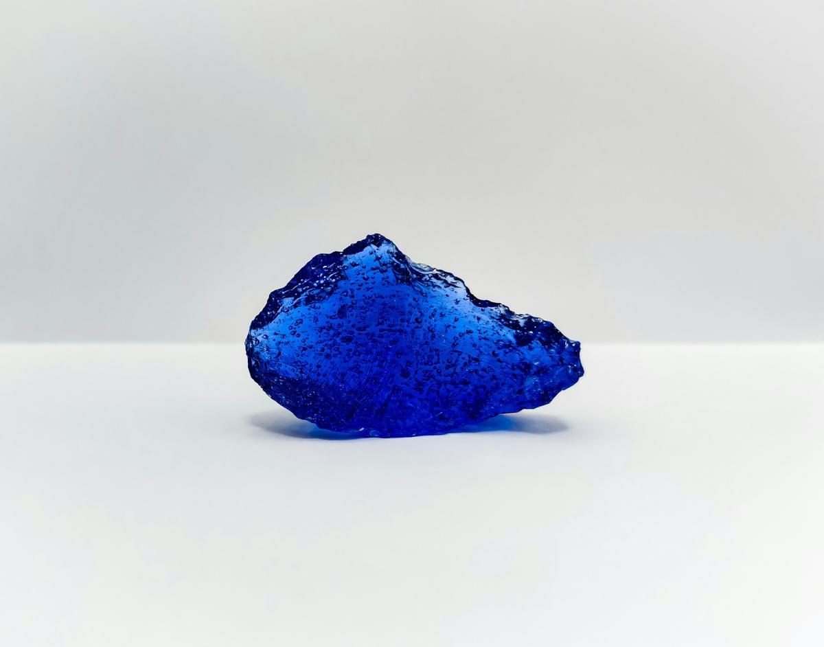 Beautiful sapphire among blue crystals showcasing elegance. Beautiful sapphire among blue crystals showcasing elegance.
