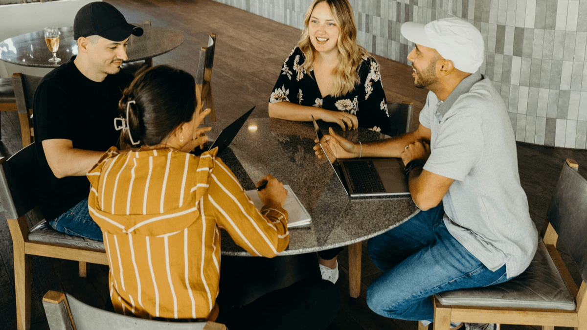 A marketing team planning an online business campaign around a table A marketing team planning an online business campaign around a table