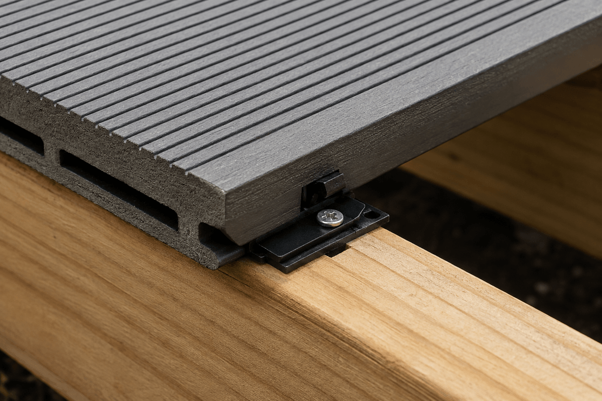 Grooved composite deck board engaging a hidden fastener clip Grooved composite deck board engaging a hidden fastener clip