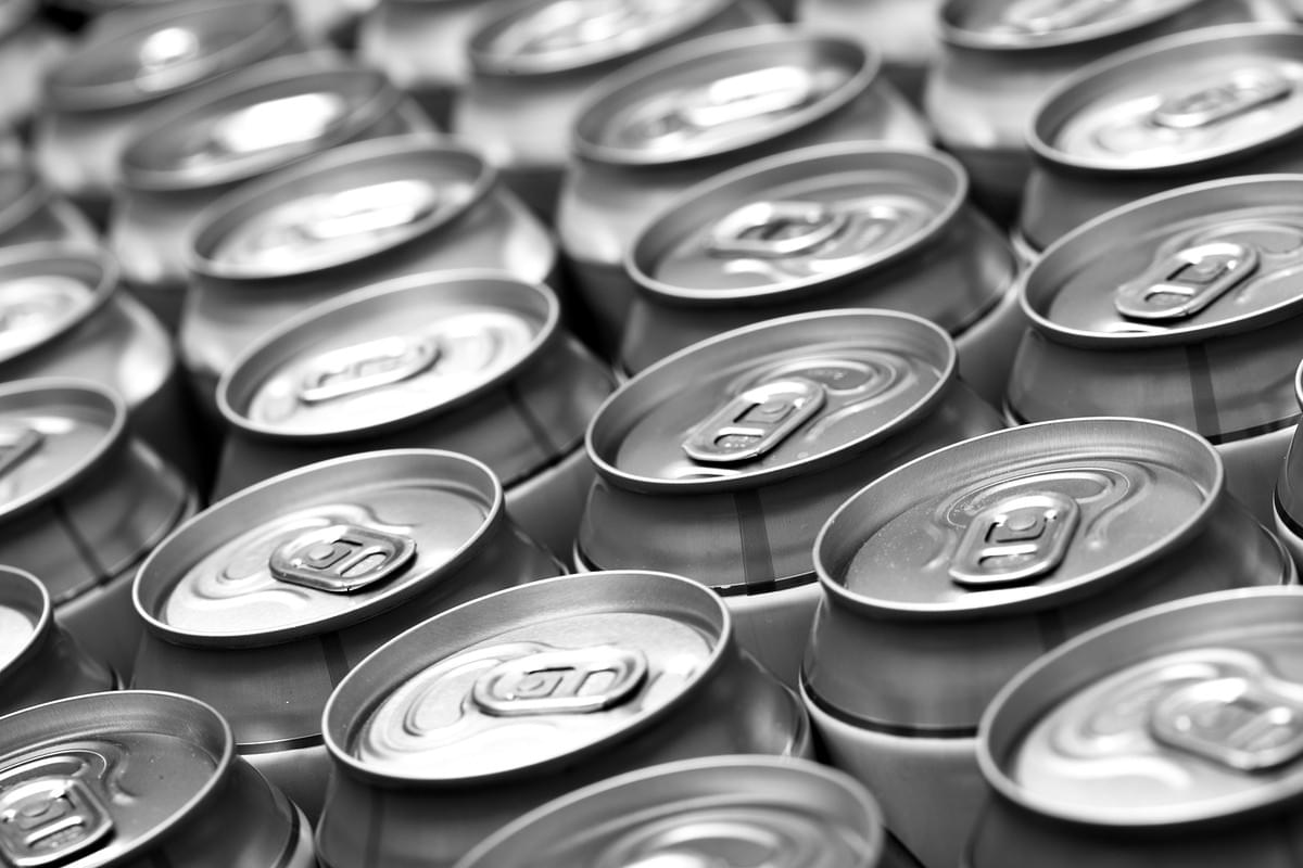 How to fill beer cans - A close-up image of a beer can being filled with golden liquid. How to fill beer cans - A close-up image of a beer can being filled with golden liquid.