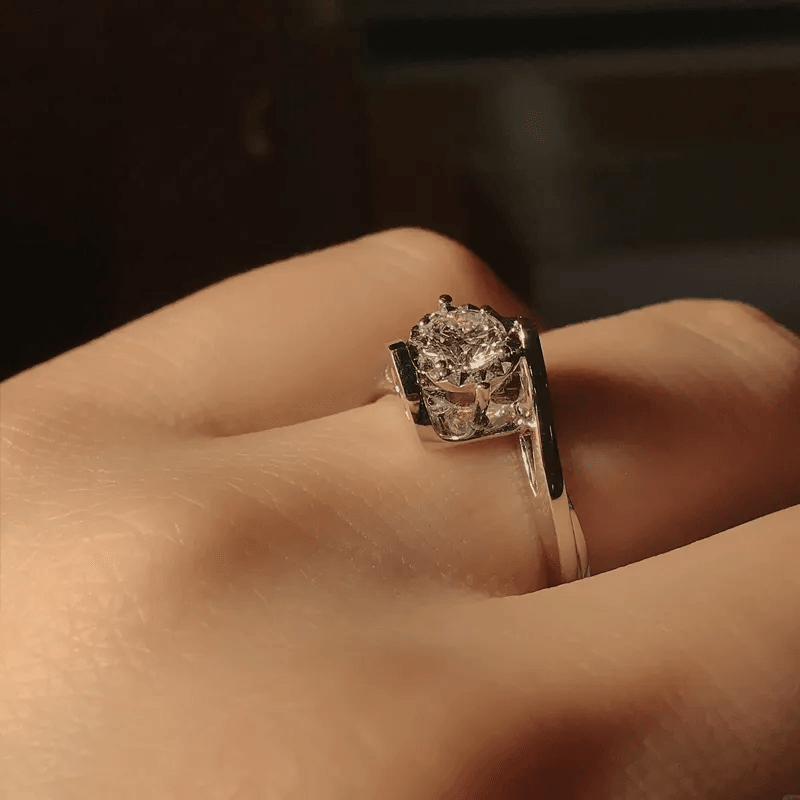 Stylish diamond-studded gold promise ring on woman's finger Stylish diamond-studded gold promise ring on woman's finger