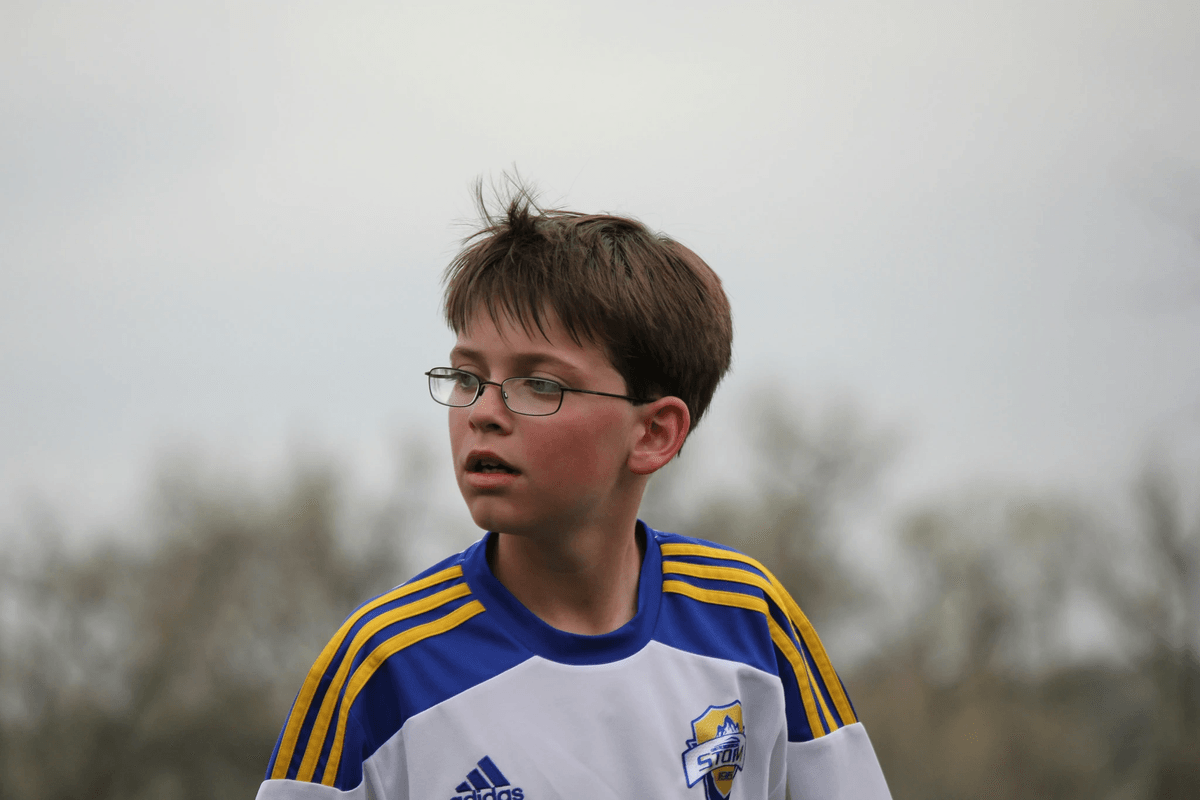 Kids sports glasses enhancing vision during soccer play. Kids sports glasses enhancing vision during soccer play.