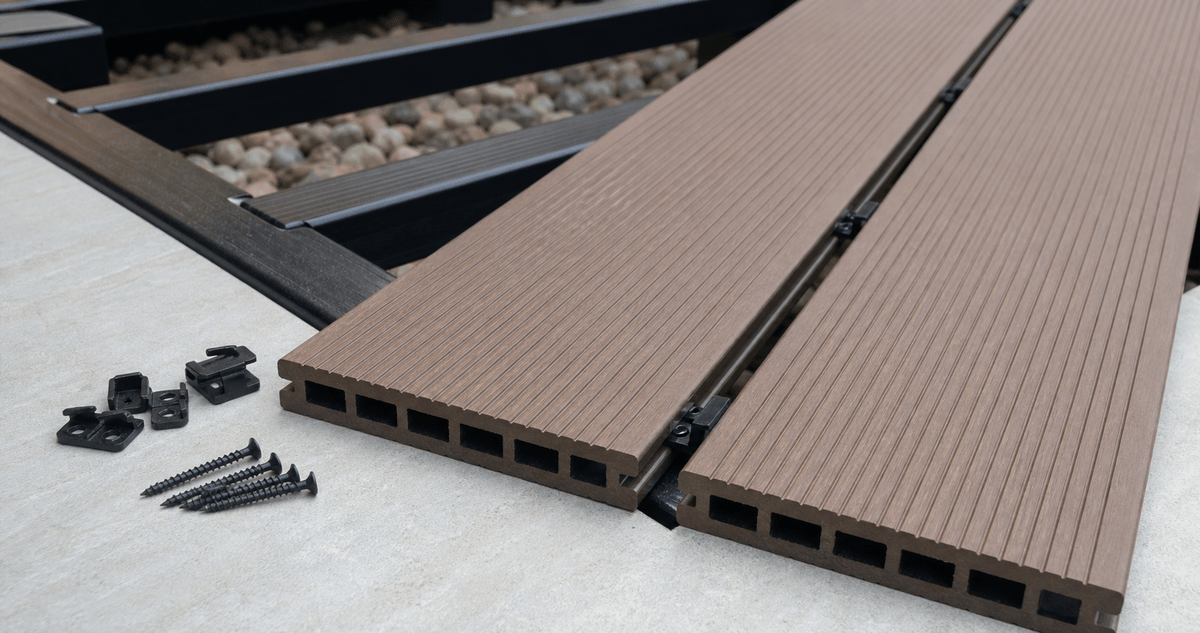 Interlocking composite deck tiles being snapped together Interlocking composite deck tiles being snapped together