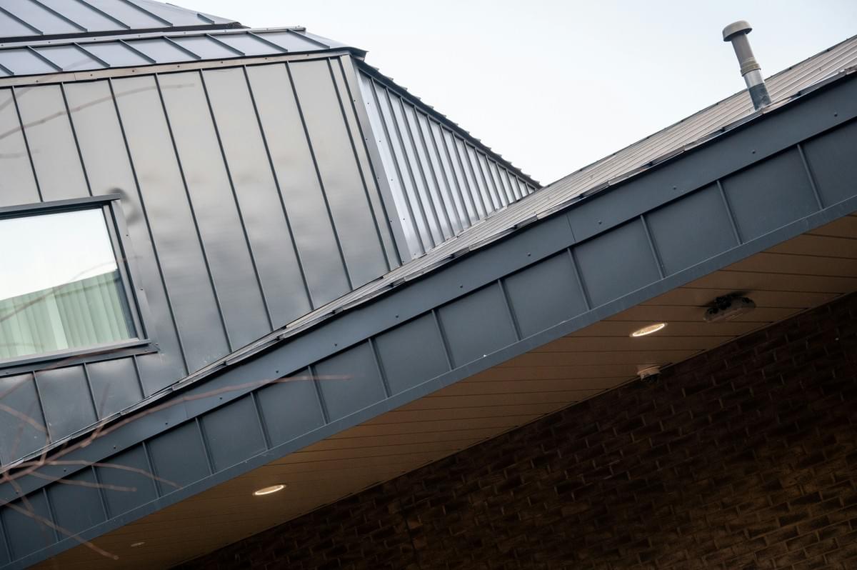 Cladding trim fitted around facade panels Cladding trim fitted around facade panels