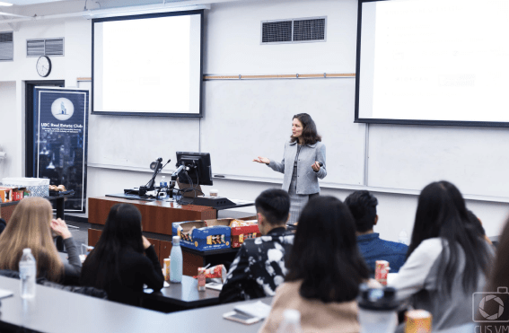 Maria teaches a full classroom of students about the basics of real estate investing. Maria teaches a full classroom of students about the basics of real estate investing.