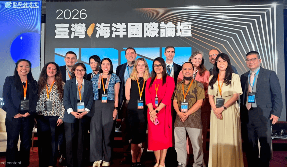 Five men and one woman sit in large padded chairs on the stage of the Taiwan International Ocean Forum. A sign in Chinese for the event and a projected slide with all of their headshots and titles are behind them. John Bradford holds the mic and is speaking thoughtfully. Jeffrey Payne is further down the line of panelists and is watching John. Five men and one woman sit in large padded chairs on the stage of the Taiwan International Ocean Forum. A sign in Chinese for the event and a projected slide with all of their headshots and titles are behind them. John Bradford holds the mic and is speaking thoughtfully. Jeffrey Payne is further down the line of panelists and is watching John.