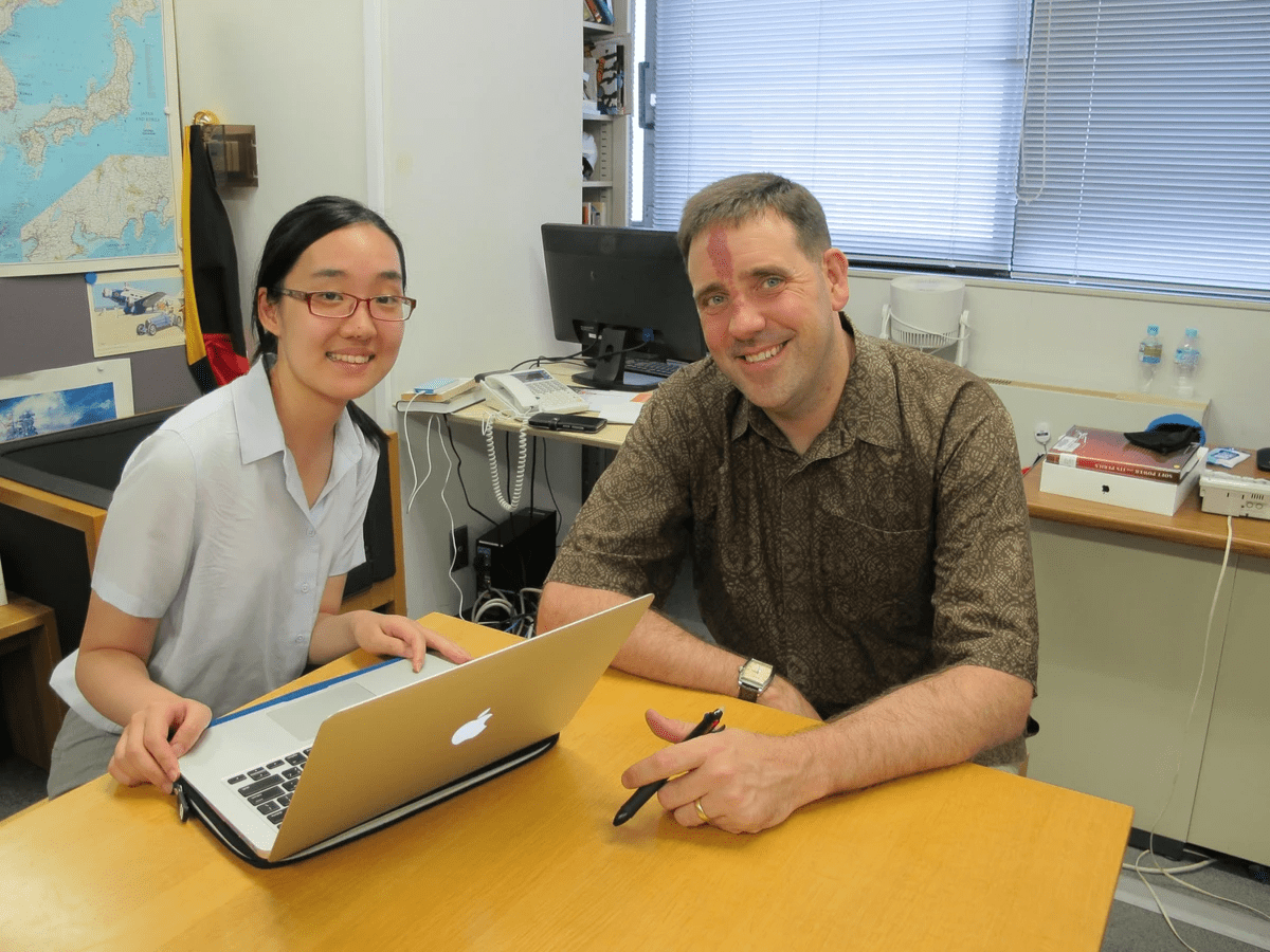 YCAPS Director sits with a young woman in a classroom while they collaborate on something on a laptop YCAPS Director sits with a young woman in a classroom while they collaborate on something on a laptop