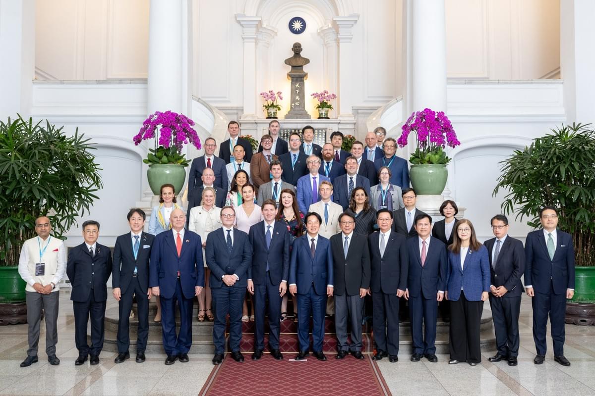 Several dozen people in suits stand on five tiers of the grand stairs of the Taiwan Presidential Residence, smiling at the camera. The president of Taiwan is in the center front. The first two rows are made up of government officials from many countries, and several YCAPS leaders are standing among the delegates in the four rows further up the stairs. Several dozen people in suits stand on five tiers of the grand stairs of the Taiwan Presidential Residence, smiling at the camera. The president of Taiwan is in the center front. The first two rows are made up of government officials from many countries, and several YCAPS leaders are standing among the delegates in the four rows further up the stairs.