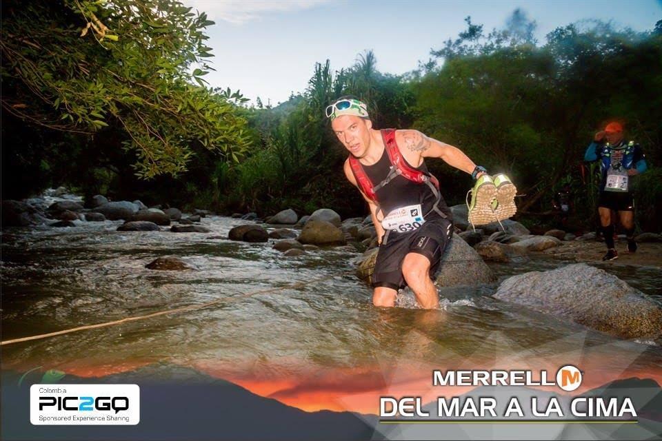 Using a guide rope to wade through a river during Del Mar a La Cima Using a guide rope to wade through a river during Del Mar a La Cima